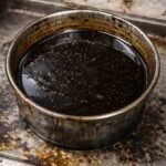 image shows that used oil is filled into a vessel.